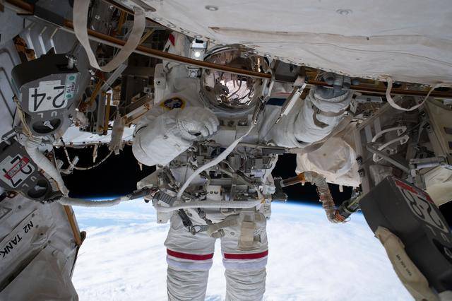 ESA astronaut Sophie Adenotis tethered to the International Space Station during a spacewalk