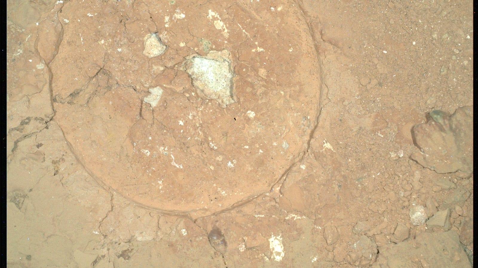 A nighttime mosaic from Perseverance's WATSON camera on an abraded patch of red rock, showing a large green spot with a dark core and a pale green rim.