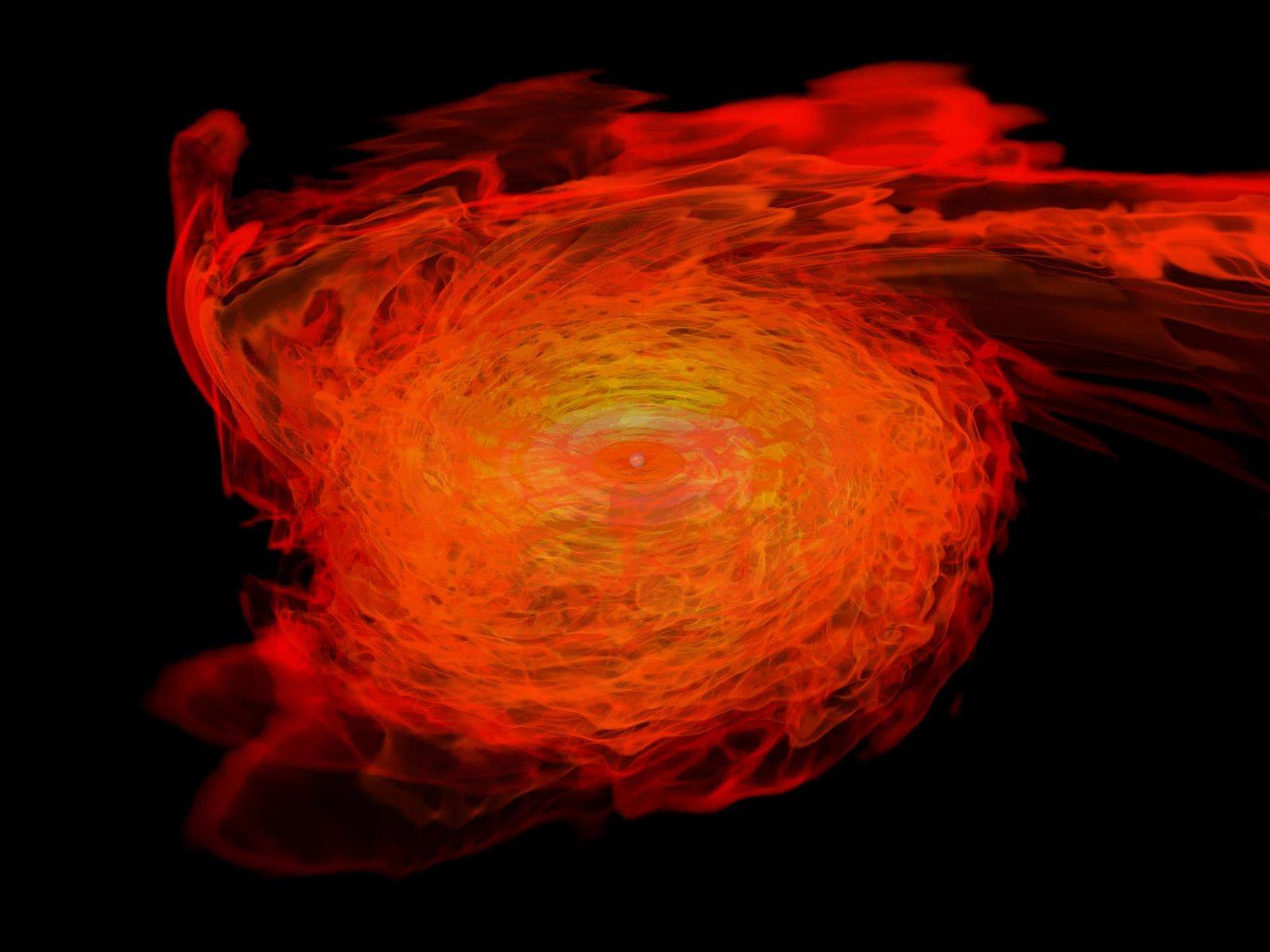Simulation of two neutron stars spiraling together, stretching as they merge into a black hole against a dark background.