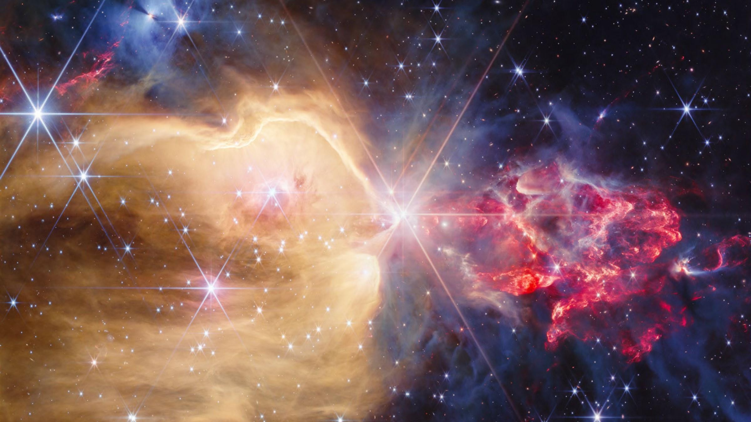 Infrared image of NGC 7129 by Webb: at center a bright star ringed by diffraction spikes, on the left a vast golden cavity dotted with blue stars, on the right a reddish plume of dust hiding protostars.