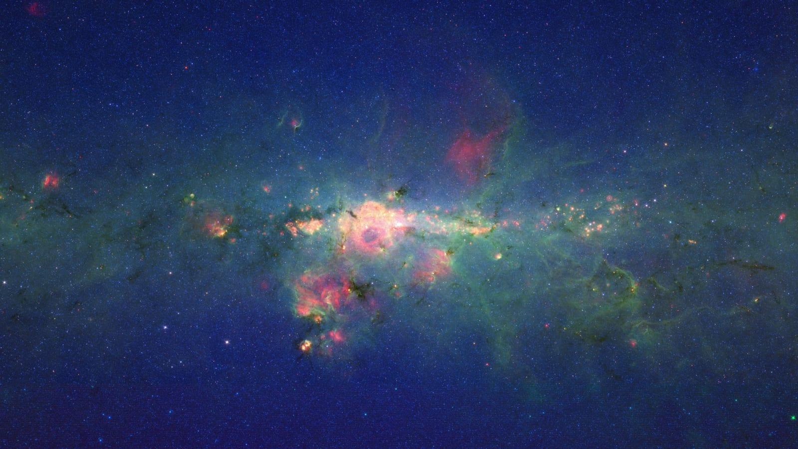 Infrared view of the centre of the Milky Way by Spitzer: dust clouds and a very dense swarm of stars around the central black hole.