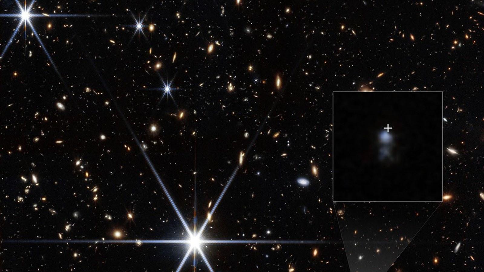An image of the radio burst's host galaxy with arrows marking north and east, a scale bar in arcseconds and a color key.