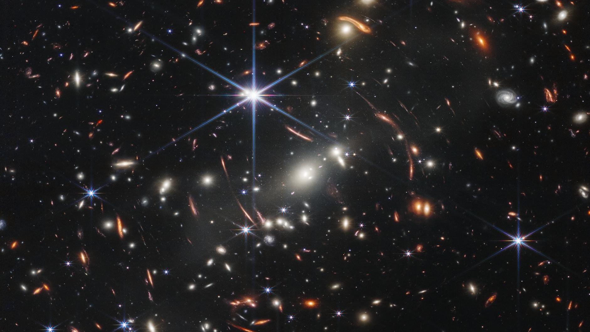 Webb's deep field image of galaxy cluster SMACS 0723: thousands of galaxies distorted into luminous arcs by gravitational lensing.