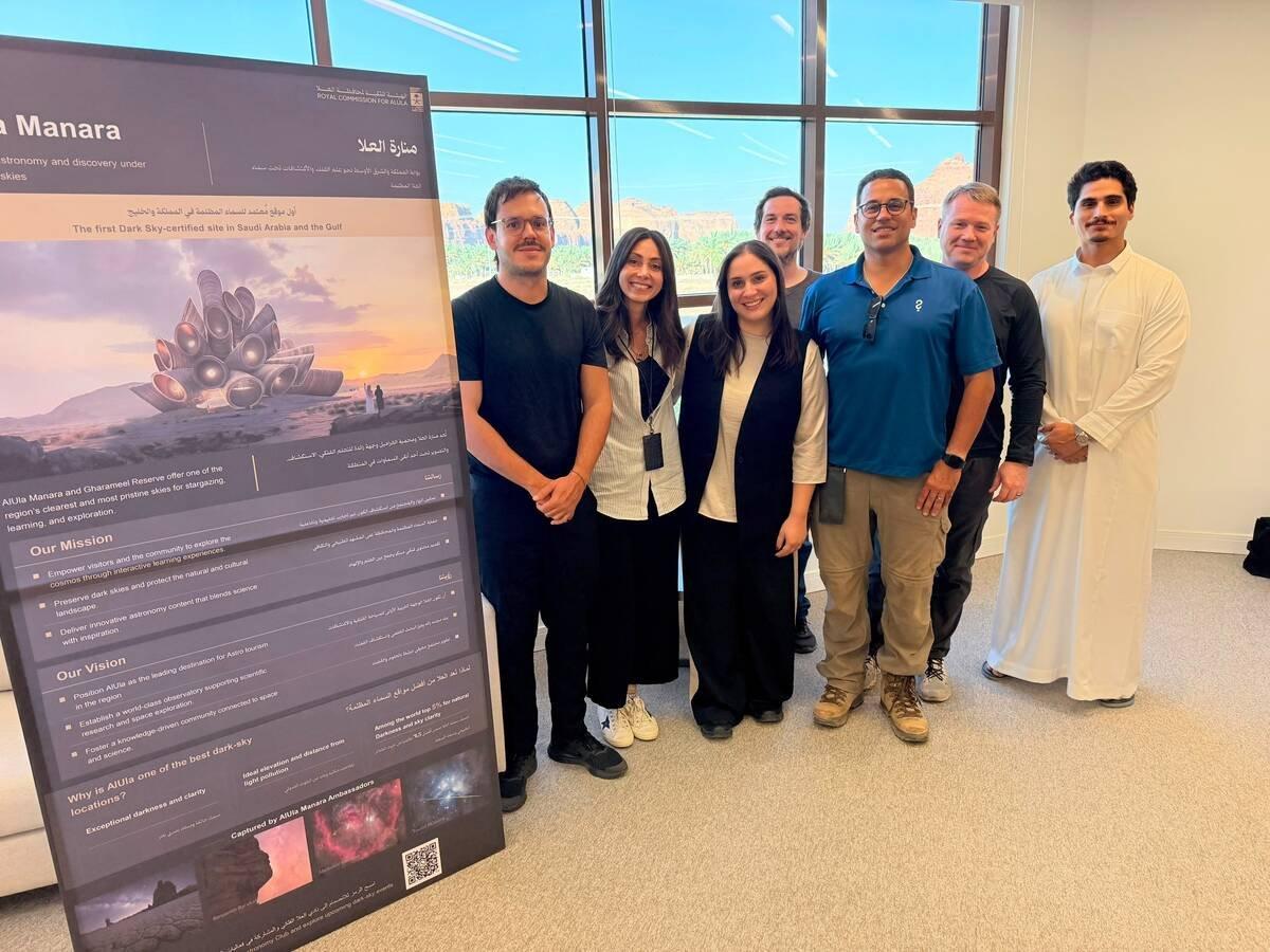 The LaserSETI installation team and members of the Royal Commission for AlUla pose in front of the stations in the desert.