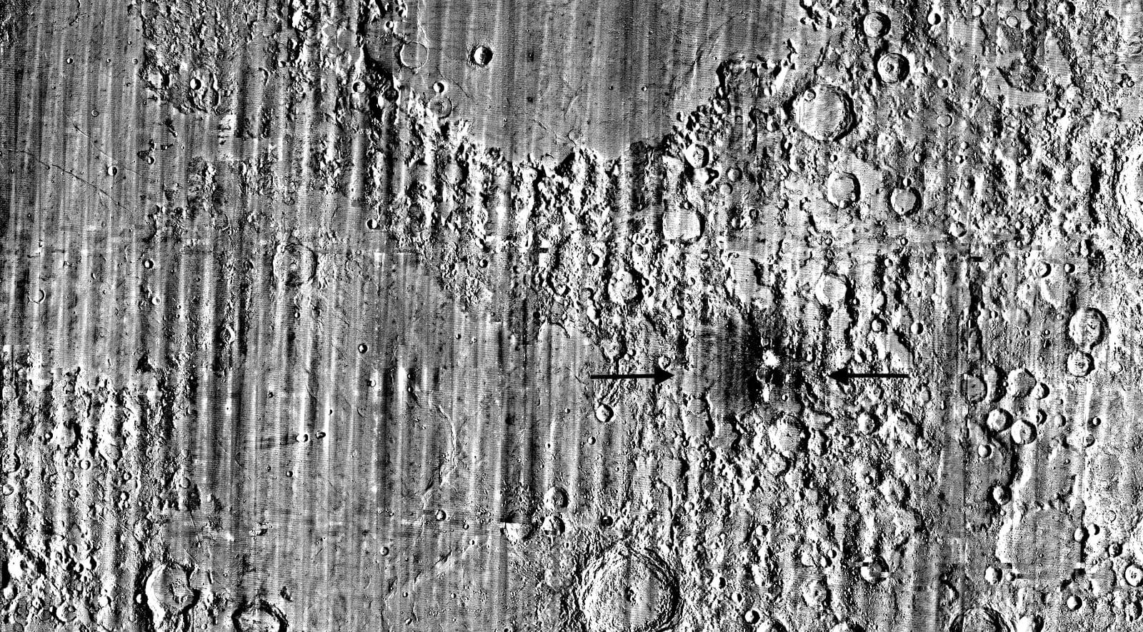 Global map of the Moon where a black arrow points to McGetchin crater on the eastern edge, just left of center.