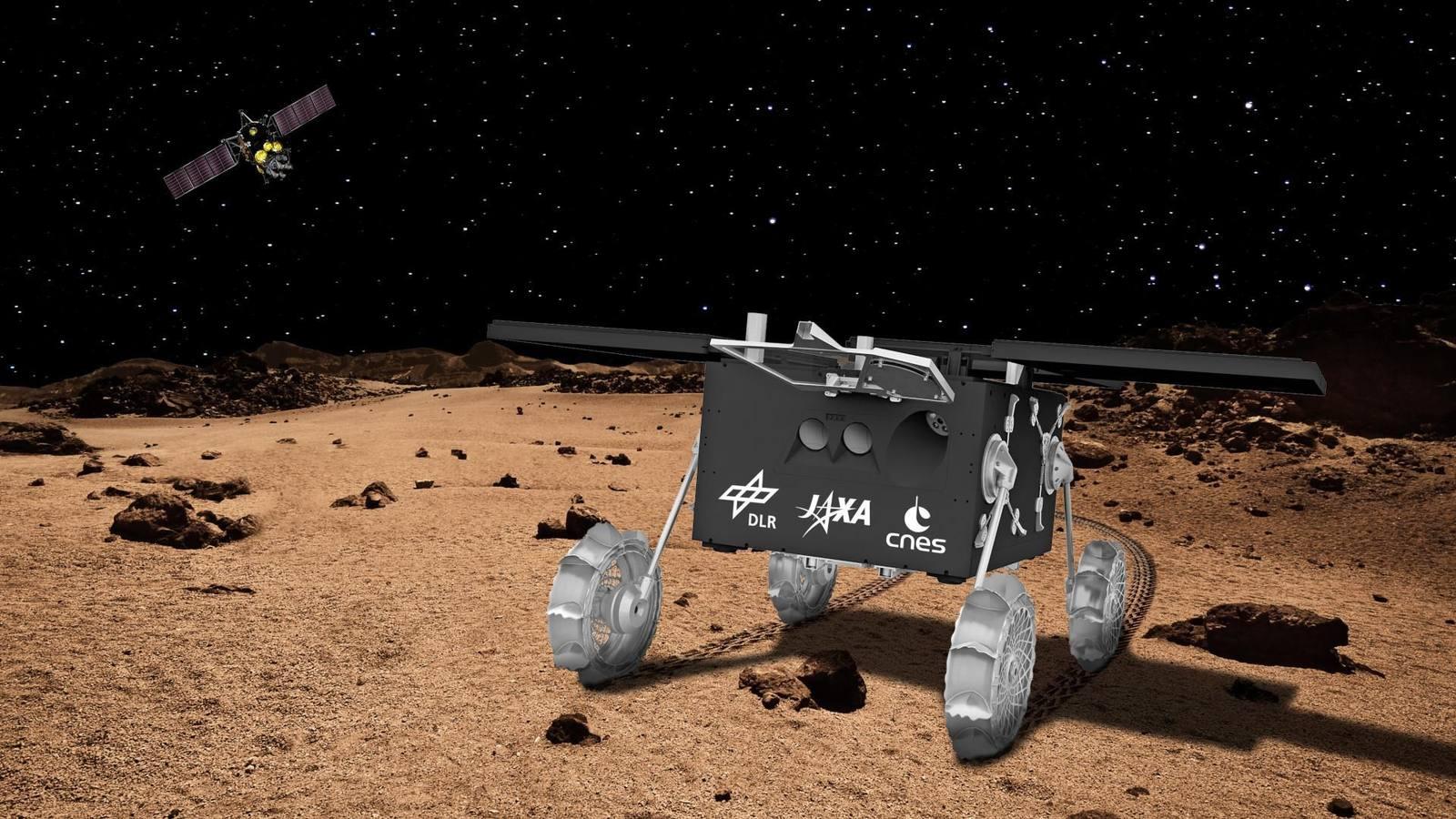 Artist's view of the IDEFIX rover on Phobos: a small four-wheeled craft on articulated legs, resting on grey, cratered ground under a black sky.