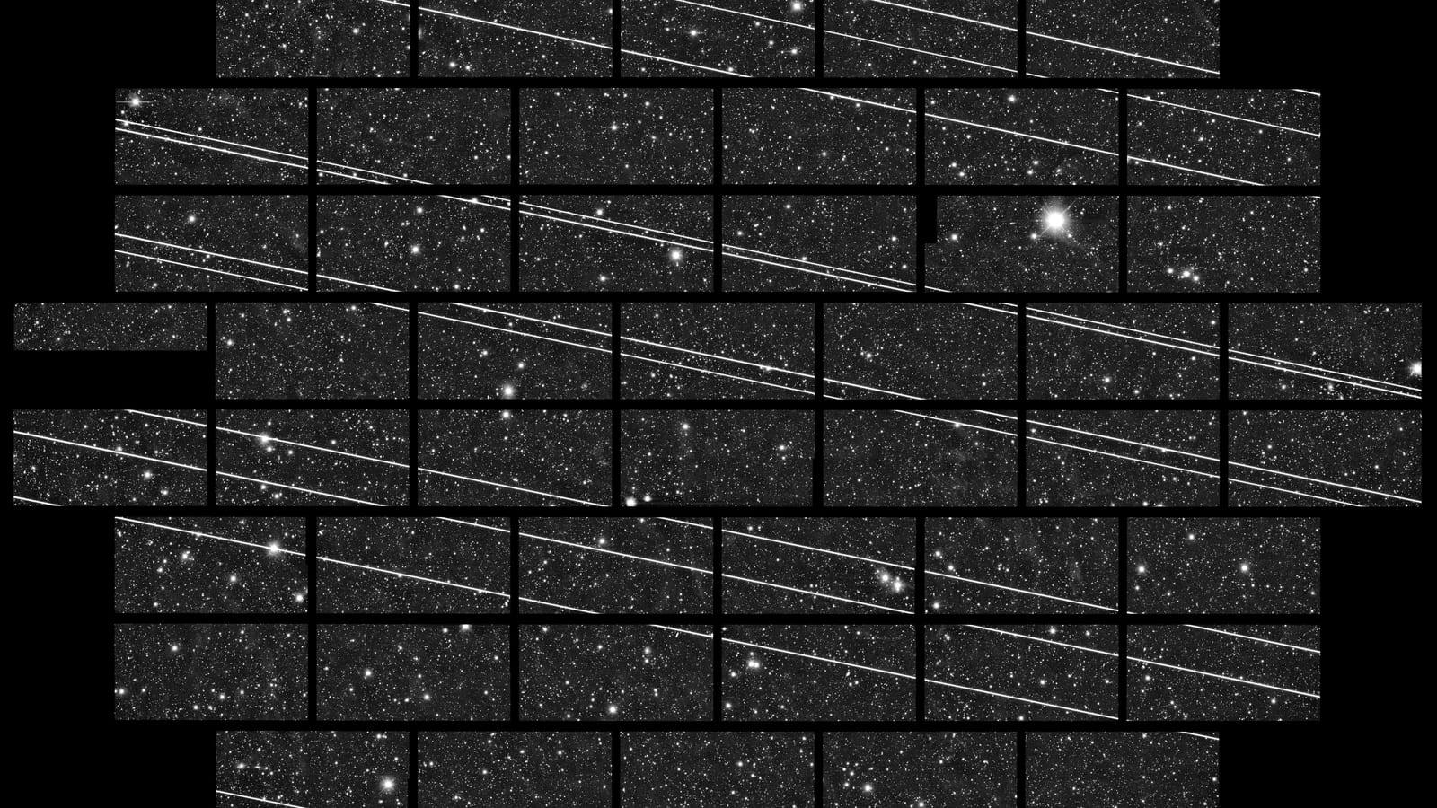 A star field crossed by nineteen long, straight, parallel streaks, some of them broken into regular segments.