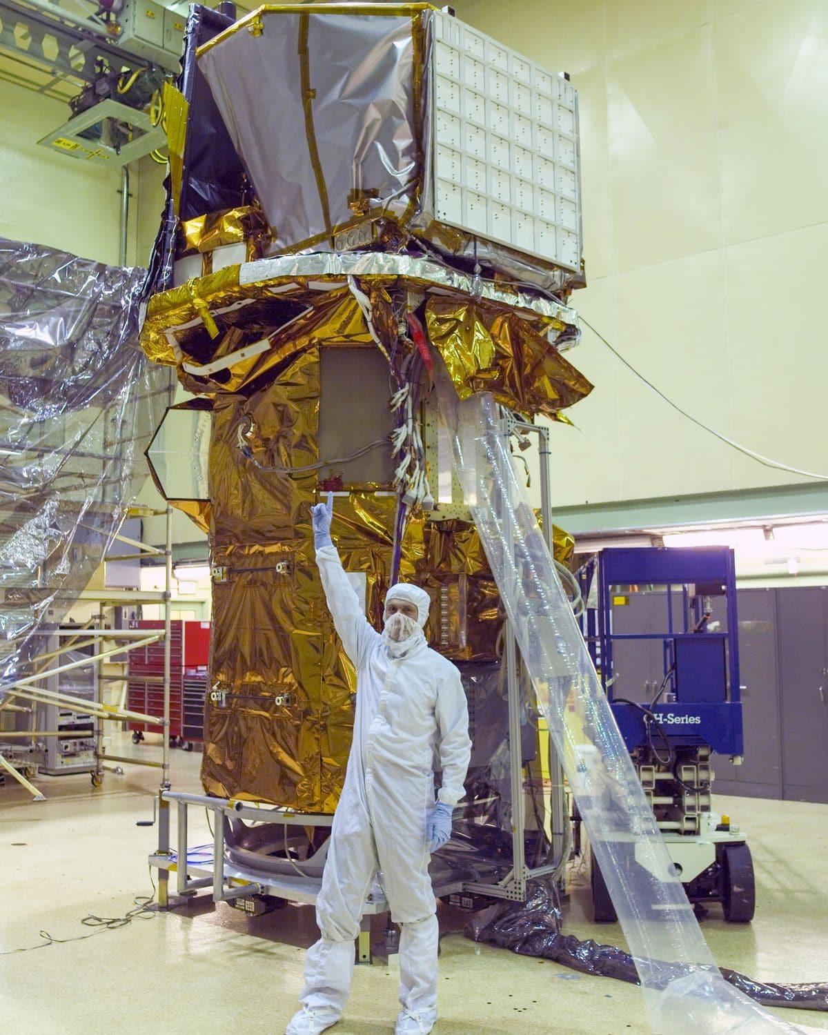 Neil Gehrels, primer responsable científico de Swift, señala los instrumentos del satélite ensamblado en una sala blanca del centro Goddard.