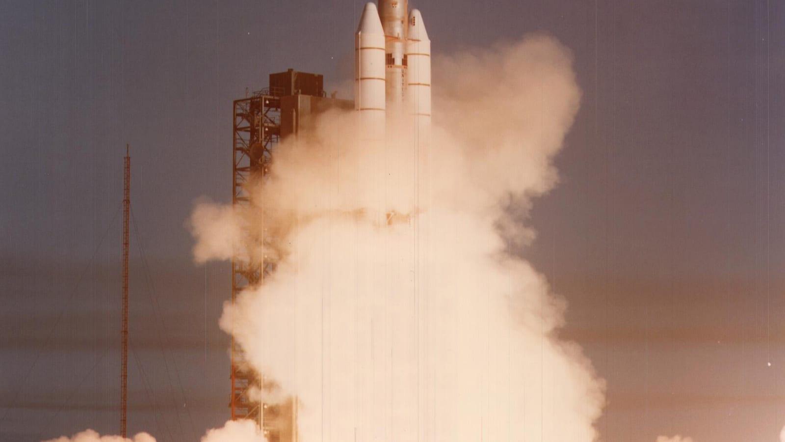 The Titan IIIE-Centaur rocket lifts off from Cape Canaveral on September 5, 1977, with Voyager 1 aboard, wrapped in a huge plume of smoke.